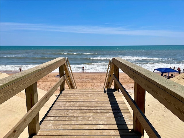 exterior space featuring a water view and a beach view