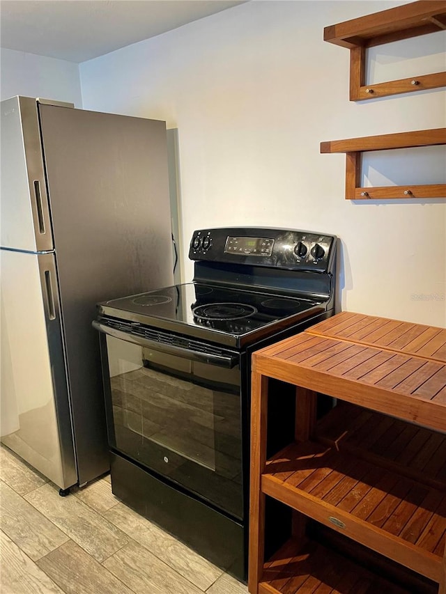 kitchen featuring light hardwood / wood-style flooring and black range with electric cooktop