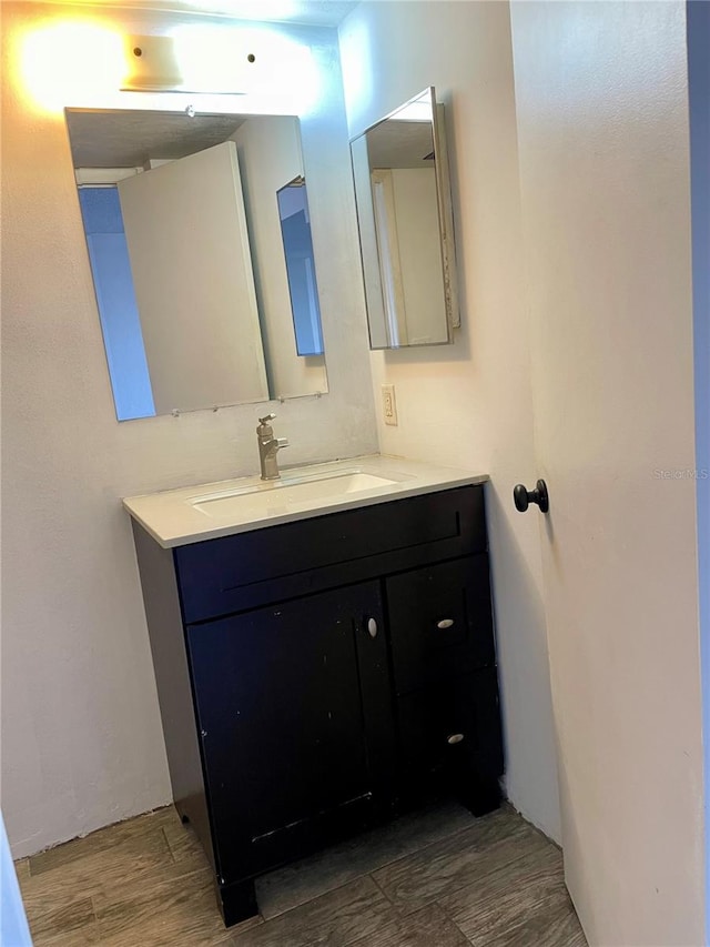 bathroom with vanity and hardwood / wood-style floors