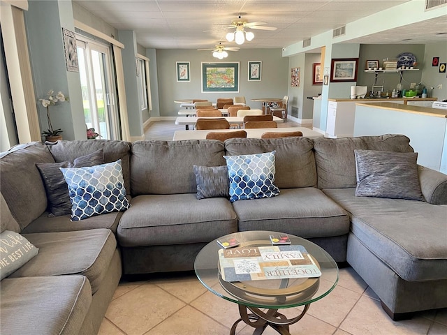 living room with light tile patterned floors and ceiling fan