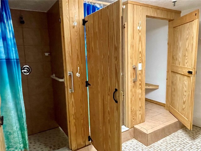 bathroom with tile patterned floors and walk in shower