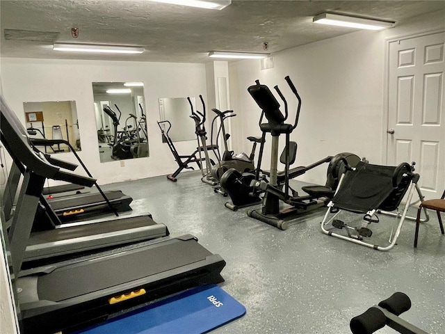 exercise room with a textured ceiling