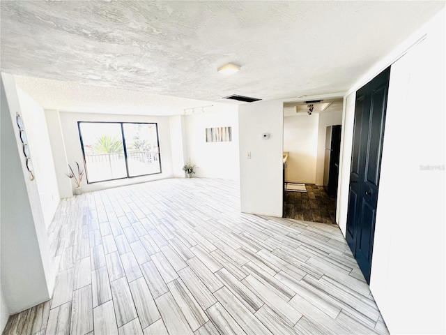 empty room with a textured ceiling