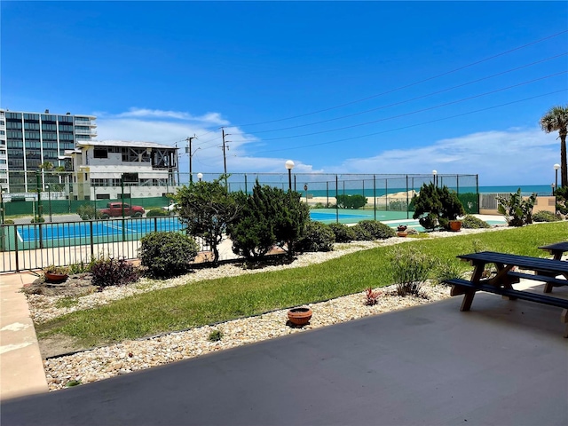 view of property's community featuring a swimming pool and a patio