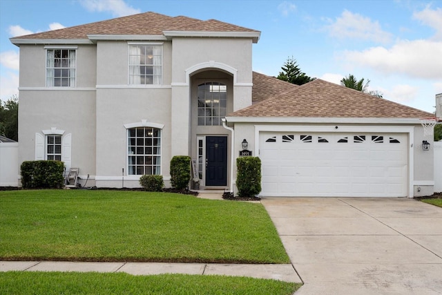 view of front facade with a garage and a front yard