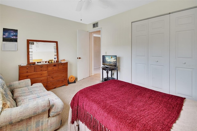 carpeted bedroom featuring a closet and ceiling fan