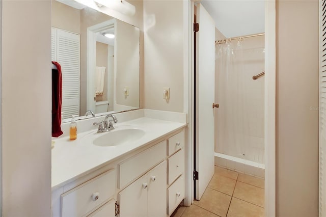 bathroom with tile patterned flooring, a shower with curtain, and vanity