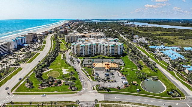 aerial view with a water view and a beach view