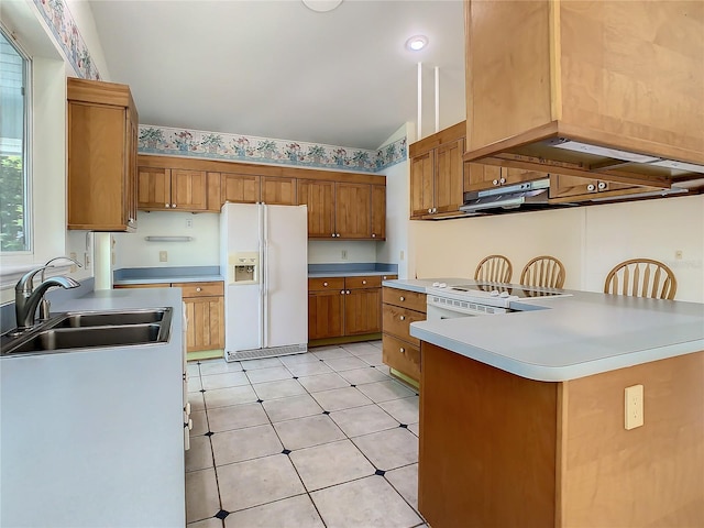 kitchen with a center island, a kitchen bar, sink, white appliances, and light tile patterned floors