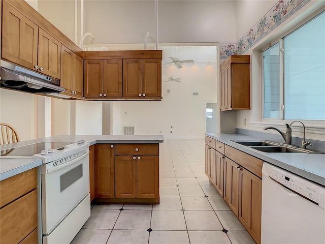 kitchen with sink, white appliances, and light tile patterned flooring