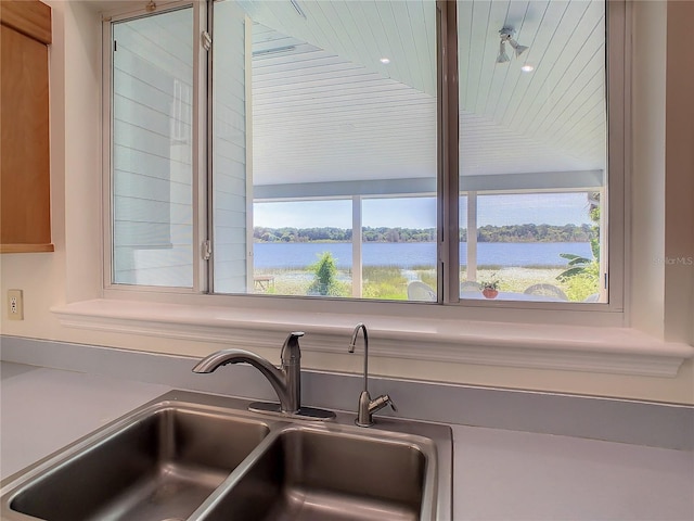 interior details with sink and a water view