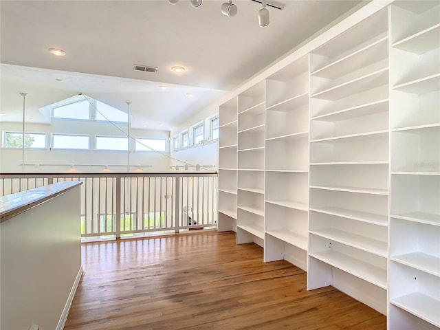 interior space with vaulted ceiling and hardwood / wood-style floors