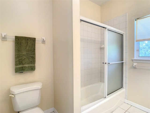 bathroom with toilet, combined bath / shower with glass door, and tile patterned flooring