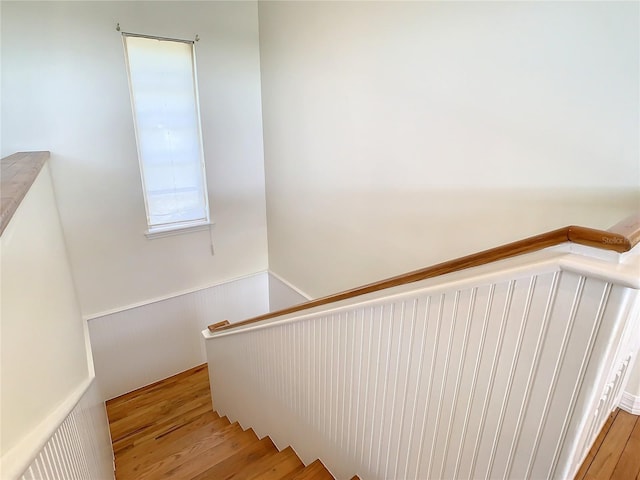 stairs featuring wood-type flooring