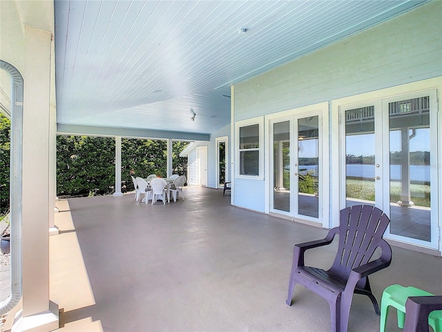 view of patio / terrace with a water view and french doors