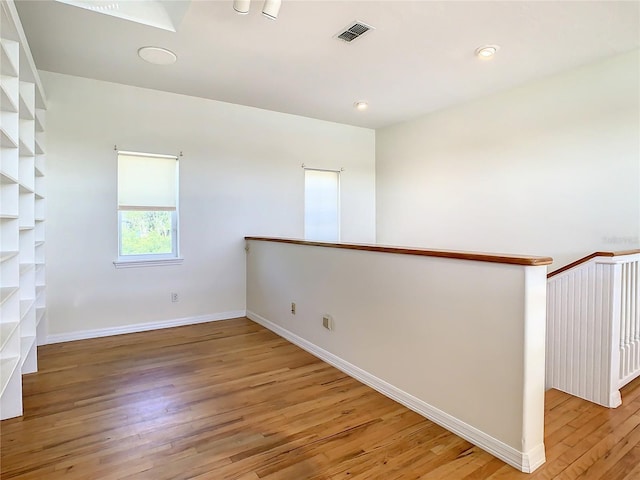 spare room featuring wood-type flooring