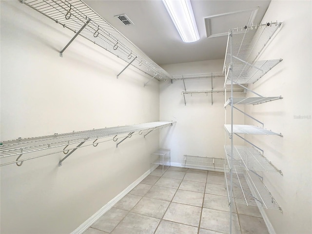 spacious closet featuring light tile patterned flooring