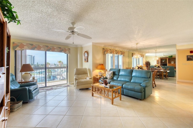 tiled living room featuring ceiling fan, a textured ceiling, and ornamental molding