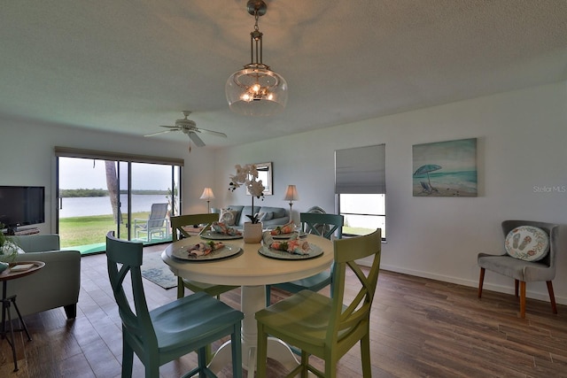 dining area featuring hardwood / wood-style floors, a textured ceiling, and ceiling fan