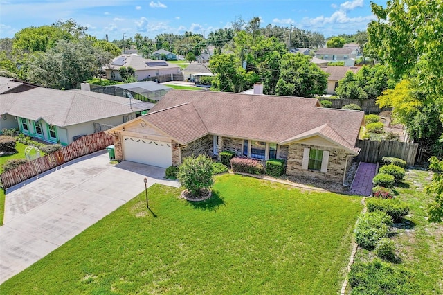 single story home featuring a garage and a front lawn