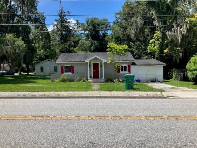 single story home with a garage and a front yard