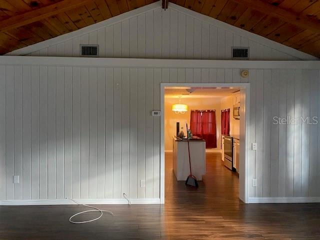 empty room with dark hardwood / wood-style floors, vaulted ceiling with beams, and wood ceiling