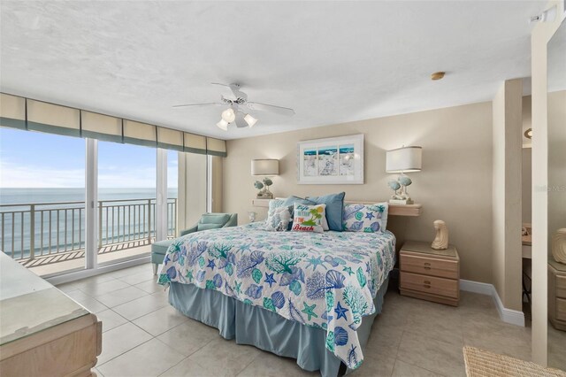 tiled bedroom featuring a water view, access to outside, and ceiling fan