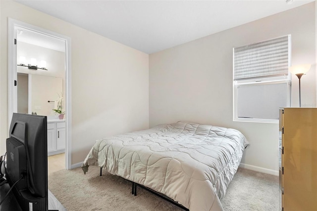 carpeted bedroom featuring ensuite bathroom