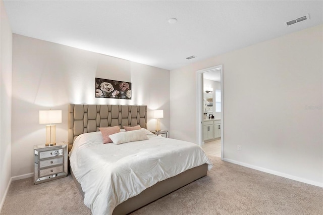 carpeted bedroom with ensuite bath