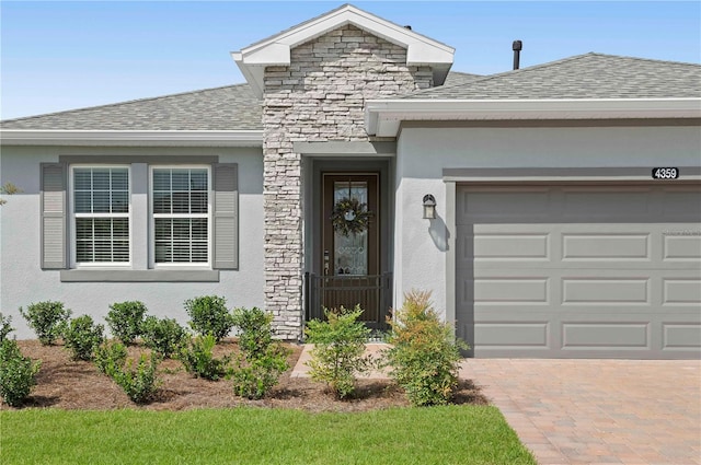 view of exterior entry with a garage