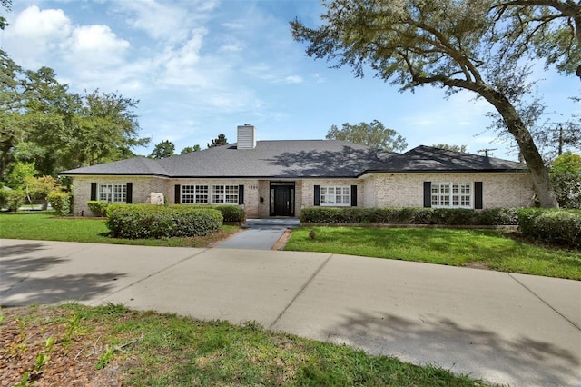 ranch-style home with a front lawn