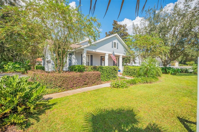 view of front of property with a porch and a front lawn