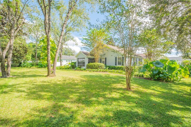 view of yard featuring a sunroom