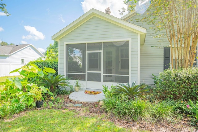 view of property exterior featuring a sunroom