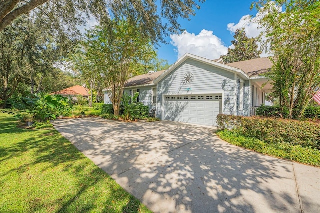 single story home with a front yard and a garage