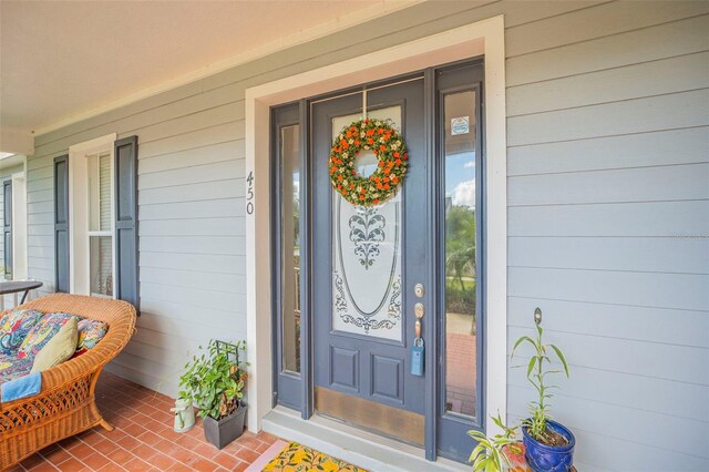 doorway to property featuring covered porch