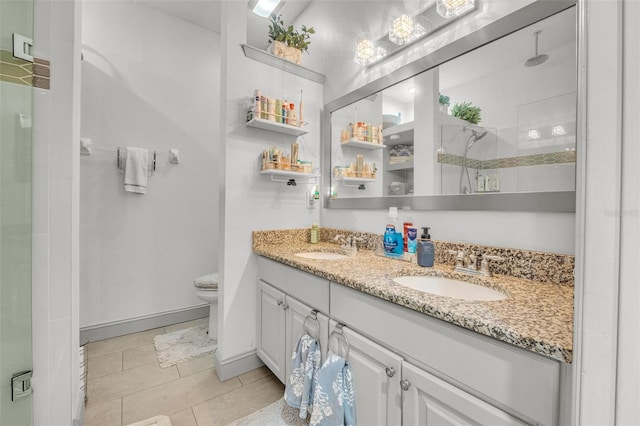 bathroom featuring vanity, a shower with shower door, toilet, and tile patterned floors