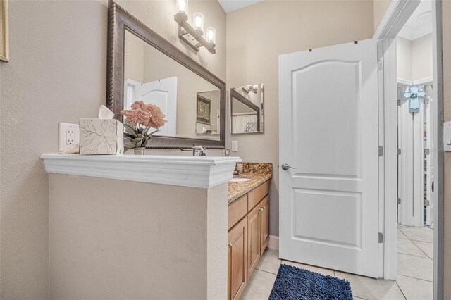 bathroom featuring tile patterned flooring and vanity