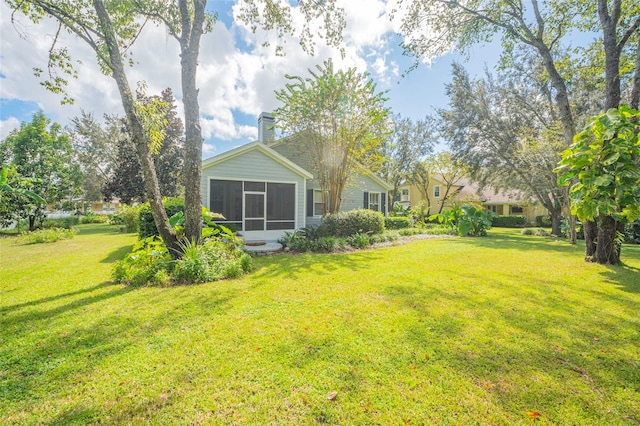 view of yard featuring a sunroom