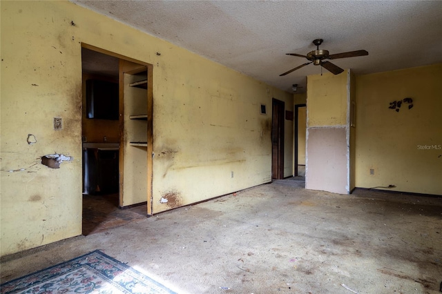 spare room with ceiling fan and a textured ceiling