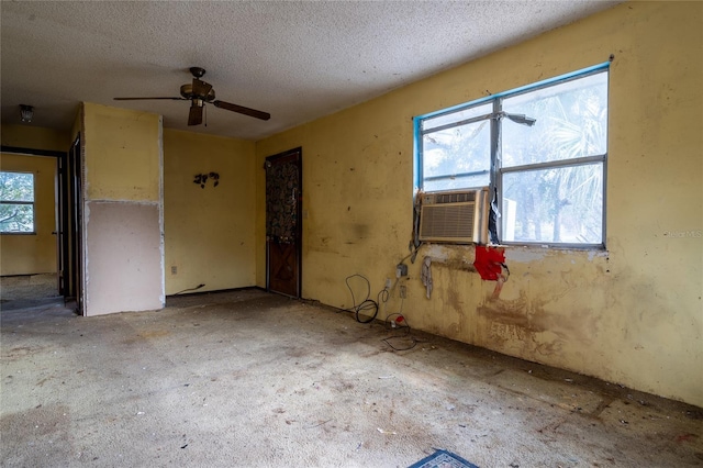 unfurnished room featuring ceiling fan, cooling unit, and a textured ceiling