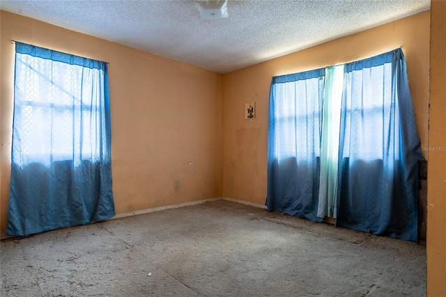 spare room with a textured ceiling