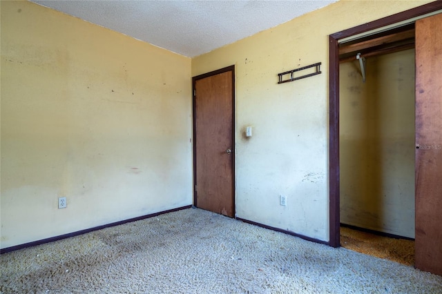 unfurnished bedroom featuring light colored carpet and a textured ceiling