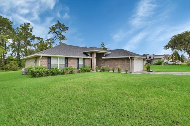 view of front of property with a garage and a front lawn