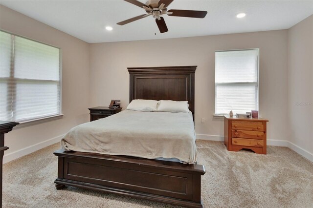 bedroom featuring light colored carpet and ceiling fan