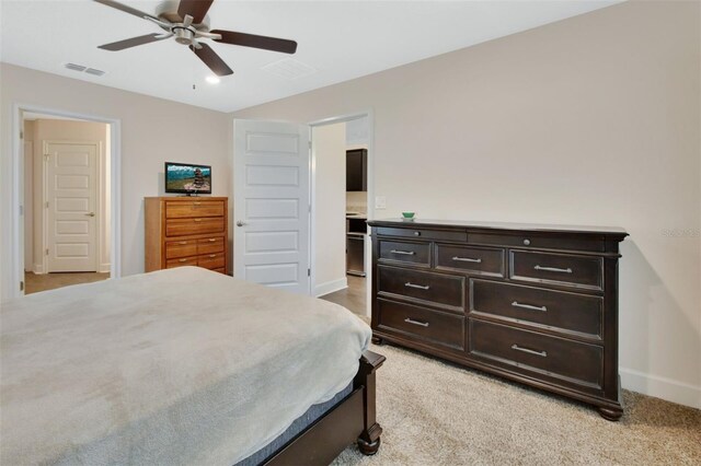 bedroom featuring light colored carpet and ceiling fan