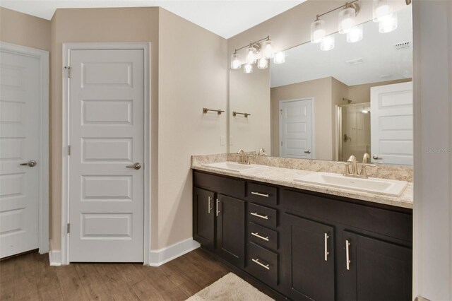 bathroom featuring vanity, a shower with door, and hardwood / wood-style floors