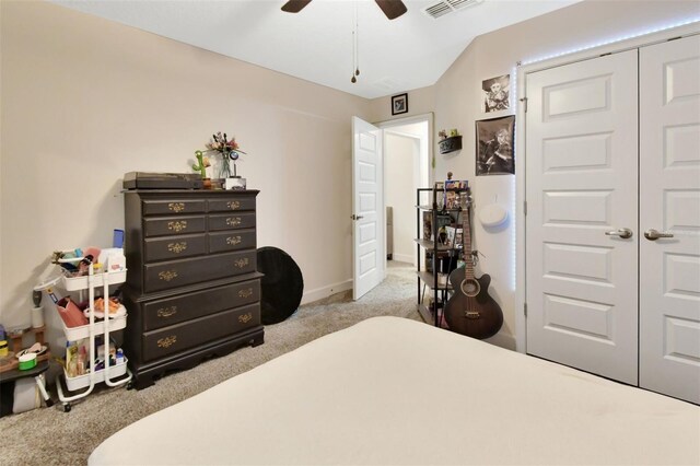 bedroom featuring light colored carpet, a closet, and ceiling fan