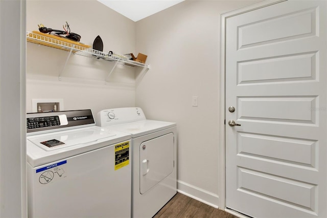 clothes washing area featuring dark wood-type flooring and washing machine and clothes dryer