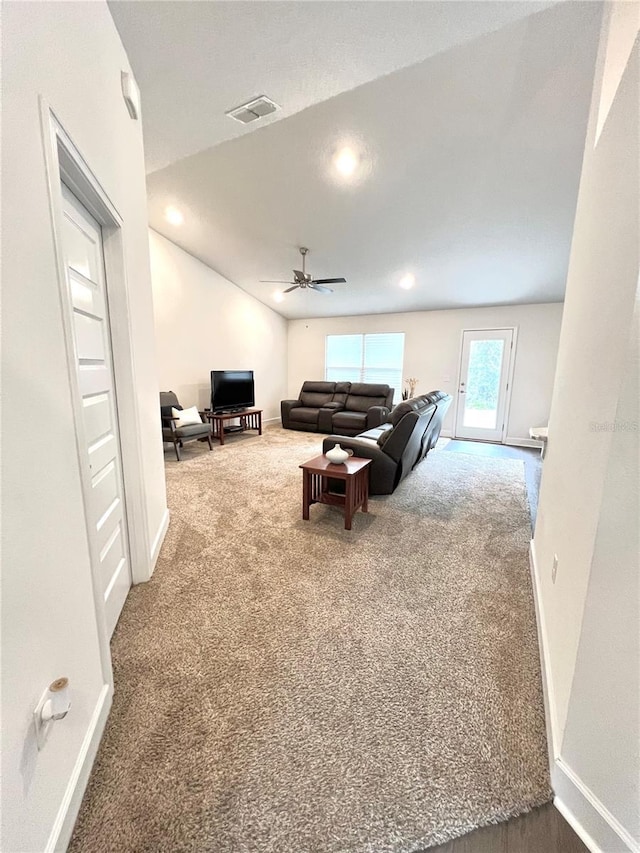 carpeted living room featuring ceiling fan